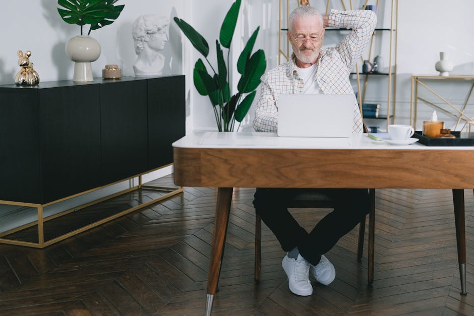Person doing a light stretch while sitting at a modern, clean home office desk